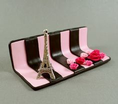 there is a pink and black tray with the eiffel tower on it