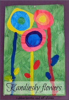 an art project made with paper and colored paint on green paper, featuring flowers in the center