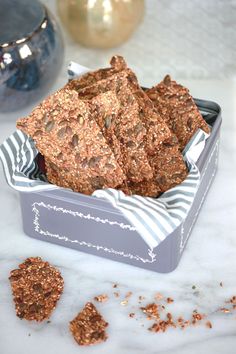 a tin filled with cookies sitting on top of a table