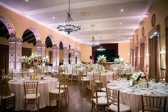 a banquet hall with tables and chairs set up for an event