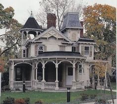 an old victorian style house in the fall