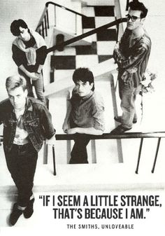 black and white photograph of four people on the stairs in front of a checkered wall