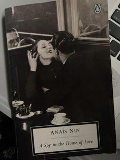 an old black and white photo of a man kissing a woman