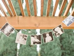 some pictures hanging from a string on a wooden chair with clothes pins attached to it