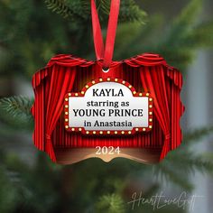 an ornament hanging from a christmas tree with the words kayla starting as young prince in australia