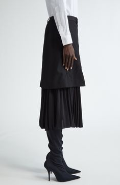 The label known for its bold innnovation plays with the proportions of a crinkled wool skirt boasting a sharply pleated underlayer. 30" length (size 38 FR) 100% wool with 100% polyester contrast Dry clean Made in Italy Designer Clothing Formal Skirt With Folds, Pleated Draped Flared Skirt For Work, Elegant Pleated Flared Draped Skirt For Work, Formal Asymmetrical Accordion Pleated Skirt, Formal Lined Tiered Pleated Skirt, Formal Asymmetrical Pleated Skirt With Lining, Fitted Formal Pleated Skirt With Folds, Fitted Asymmetrical Skirt For Layering, Formal Pleated Tiered Skirt