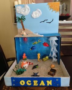 an ocean scene made out of cardboard and sand