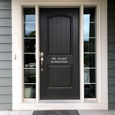 a black front door on a gray house