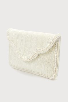 Make your big day look truly unique with an extra special accessory like the Lulus Immaculate Radiance White Pearl Beaded Clutch! The front of this stunning bag is adorned with an array of shiny beaded details and trimmed with gleaming faux pearls along the perimeter of the rectangular silhouette and scalloped front flap. Lift the hidden magnetic closure to reveal a lined interior with a sidewall pocket and plenty of room for all your bridal necessities! Detachable silver chain strap included. Lined. Clutch measures 10. 5" wide, 7" tall, and strap has 20. 5" drop. 100% Cottton. Spot Clean Only. Imported. Lulus | Immaculate Radiance White Pearl Beaded Clutch. Bridal Necessities, Pearl Clutch, Lulu Fashion, Bridal Clutch, Pearl Bridal, Beaded Clutch, Bridal Pearls, Hair Ornaments, White Beads