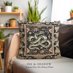 a decorative pillow on a chair in front of a potted plant and bookshelf