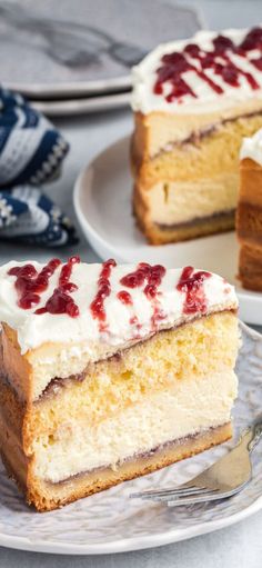 a slice of cake with white frosting and raspberry topping