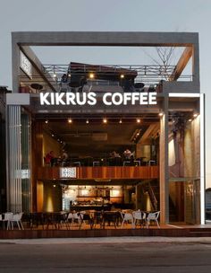 the entrance to kirrus coffee is lit up at night