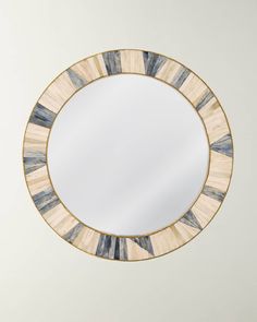 a round mirror hanging on the wall