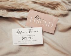 two coupons sitting on top of a bed next to a fur coat and pillow