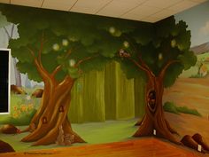 a room with a mural on the wall and trees painted on the walls in front of it