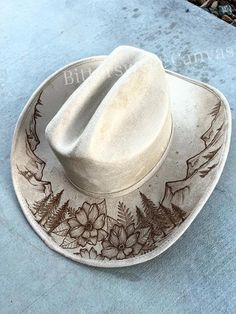 This boho western hat would be perfect with just about any outfit. It is a stiff hat, made of high quality vegan suede, meant to hold its shape.  If you'd like completely custom design instead, please go to this link to order one made just for you! https://etsy.me/3rod0CN 💜 H A T   S I Z I N G   Tightening band inside  Hat Circumference: 20.5-23" Brim Width: 4" Extra large size available, upon request  💜 S H I P P I N G Turnaround time can take 2-3 weeks depending on how many orders I have, and how detailed your design is.  I ship USPS  💜 R E T U R N S   &   E X C H A N G E S Being that my items are so customized to your specifications, I do not offer refunds or exchanges. Please check your sizing before ordering, as I cannot refund or exchange due to hat sizing issues. BUT if there is Cowboy Hat Design, Custom Cowboy Hats, Hat Flower, Rancher Hat, Painted Hats, Western Hat, Wide Brim Fedora, Floral Hat, Wedding Hat