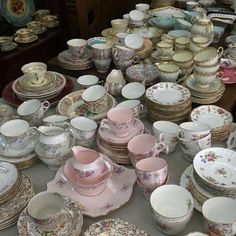 a table topped with lots of different types of dishes and cups on top of each other