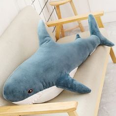 a stuffed shark sitting on top of a couch