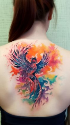 the back of a woman's shoulder with colorful watercolors on it and a bird