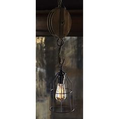 a light that is hanging from a wire and has an old fashioned bulb attached to it