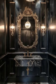 a fancy bathroom with black walls and marble counter tops, gold accents and chandelier