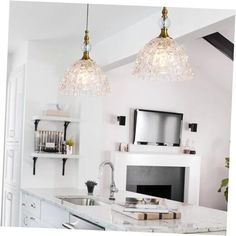 two lights hanging over a kitchen counter top