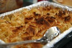 a casserole dish that has been cooked and is ready to be eaten with a serving spoon