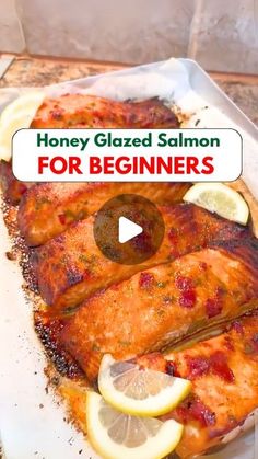 a video showing how to make honey glazed salmon for beginners with lemons and herbs