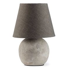 a lamp that is sitting on top of a table with a shade over the base