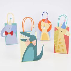 four small gift bags with animals on them