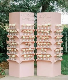 two pink shelves with flowers on each shelf