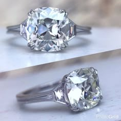 an oval cut diamond sits on top of a white countertop next to a ring with three prongs