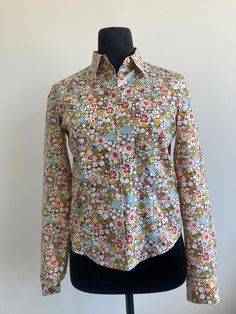 Cacharel button-up blouse Excellent vintage condition but is not brand new and therefore please expect some reasonable wear and tear Fits like a size small Measurements: Waist: 29 inches Bust: 34 inches Shoulder: 36 inches Length: 23 inches 100% Cotton Classic Floral Print Button-up Top, Classic Floral Print Button-up Shirt, Classic Collared Tops With Floral Print, Classic Collared Top With Floral Print, Daywear Floral Print Button-up Shirt, Classic Button-up Shirt With Floral Print, Classic Floral Print Tops For Daywear, Casual Fitted Blouse With Vintage Print, Fitted Floral Print Blouse With Collared Neckline