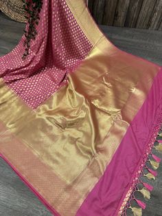 Glamorous Banarsi saree in rogue pink with gold zari butas all throughout and tassels on the palla Fall attached. Matching blouse fabric included. Note: The color of the products may slightly vary according to the ambient lighting conditions and the color calibration of LED devices. If you would like more clarity before your purchase, please drop us a message . Banarasi Silk Pre-draped Saree For Celebration, Festive Celebration Katan Silk Pre-draped Saree, Bollywood Style Gold Pre-draped Saree With Pallu, Traditional Gold Pre-draped Saree For Navratri, Gold Chandbali Pre-draped Saree For Diwali, Diwali Gold Pre-draped Chandbali Saree, Pink Bollywood Pre-draped Saree With Meenakari, Festive Celebration Pre-draped Saree With Zari Weaving, Gold Banarasi Silk Choli With Zari Work