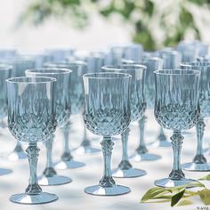 many empty wine glasses lined up on a table