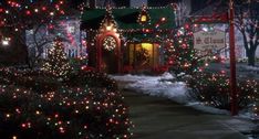 christmas lights decorate homes and trees on a street