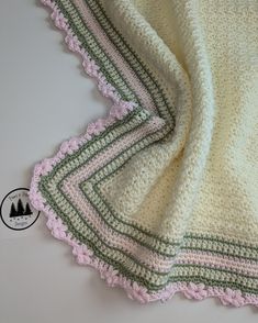 a crocheted blanket laying on top of a table