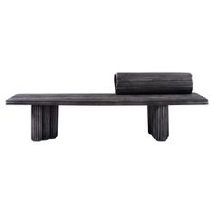 a black bench sitting on top of a wooden table next to a roll of paper