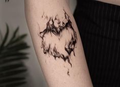 a person with a tattoo on their arm that is covered in black and white ink