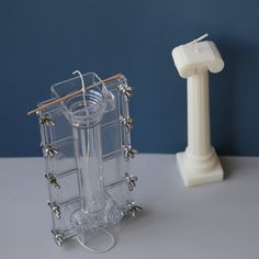 a clear plastic object next to a white lamp