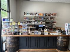 the inside of a liquor store with two wooden barrels