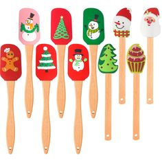 wooden spatulas decorated with christmas decorations and snowmen, all in different colors