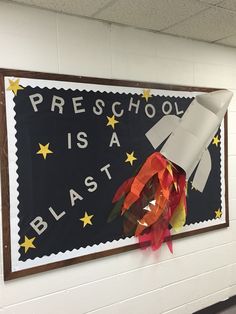 a bulletin board with a rocket ship on it's side and the words preschool is a blast