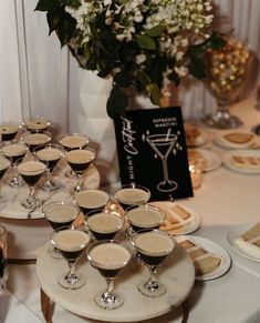 there are many glasses on the table ready to be filled with drinks and garnishes