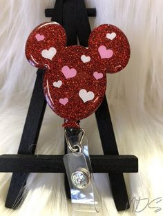 "Cute mouse ear Valentine badge reel, great gift, select alligator or belt clip style. A C R Y L I C P I E C E 2 inches | 1/8\" thick acrylic | hand glittered | sealed with resin for a smooth shiny finish and durability | hand designed with vinyl | Velcro or magnet option attached to badge reel so they can be easily changed out with other designs if desired. B A D G E R E E L S 24\" retractable cord | 1-1/4\" in diameter. Snap clip glitter may vary but I try to make them neutral so they can be u Valentines Badge Reel, Diy Crafts Keychain, Badges Diy, Valentines Balloons, Teacher Badge, Id Badge Reels, Book Markers, Cute Mouse, Nurse Badge Reel