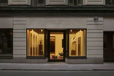 a store front with the lights on and windows lit up