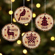 three wooden ornaments hanging from a christmas tree