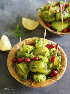 cucumber and pomegranate salad with toothpicks on wooden plates