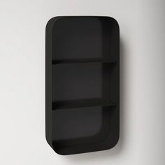 a black shelf mounted on the wall