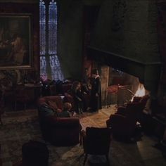 a living room filled with furniture and a fire place in the middle of it's walls